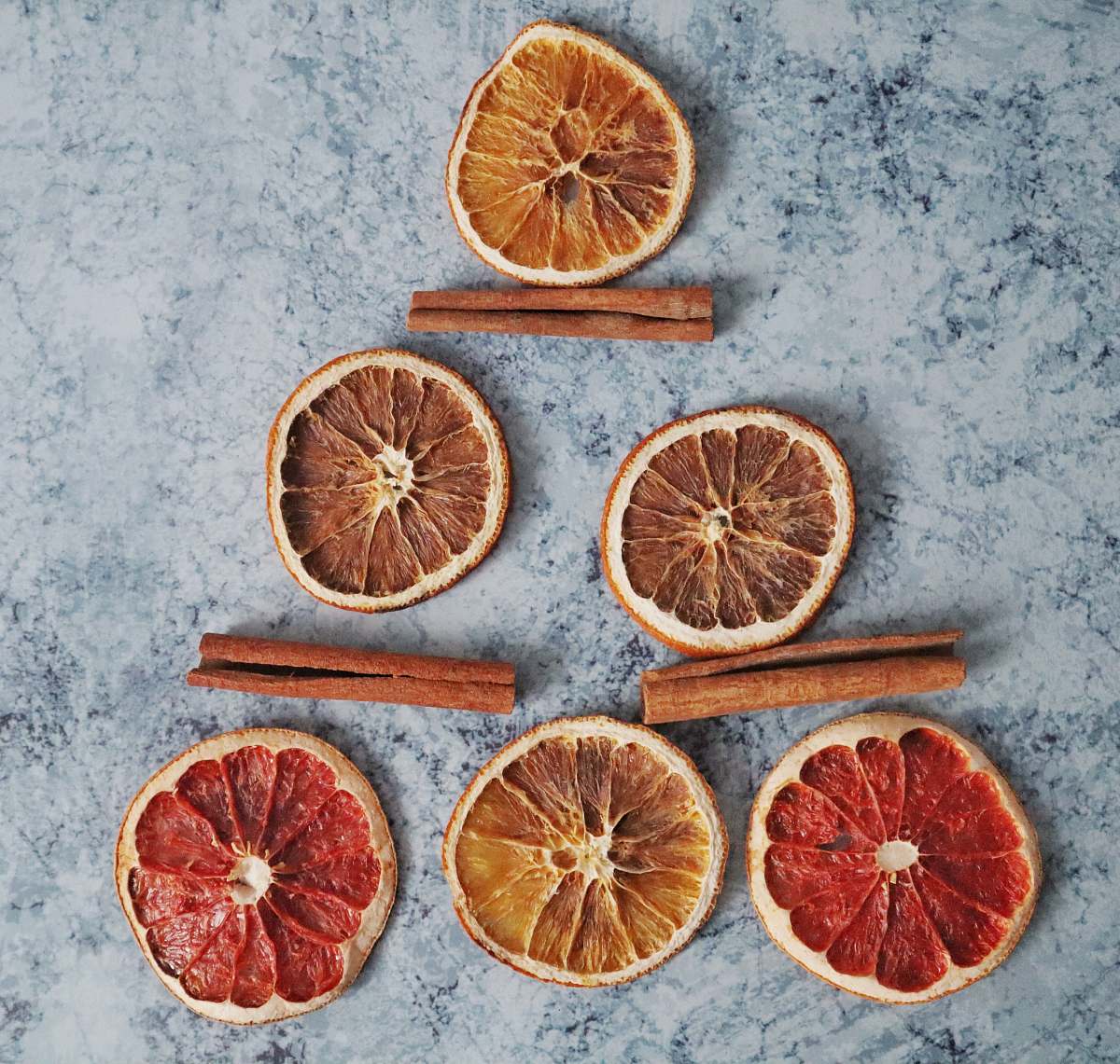 citrus fruit sliced grapefruit near three cinnamon plant